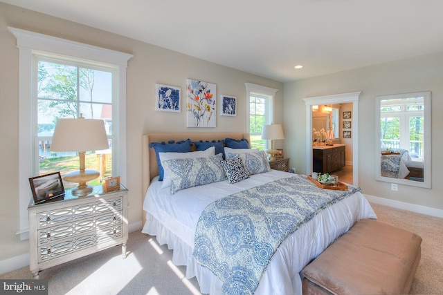 carpeted bedroom with connected bathroom