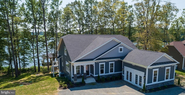 view of front of home featuring a front yard, a patio area, and french doors