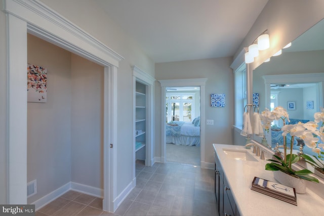 bathroom with tile floors, ceiling fan, and large vanity