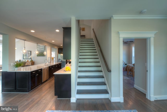 staircase with dark hardwood / wood-style flooring and sink