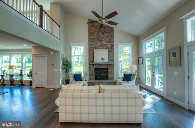 living room featuring high vaulted ceiling, dark wood-type flooring, ceiling fan, and plenty of natural light