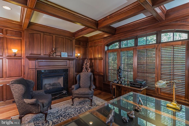 living room with a premium fireplace, coffered ceiling, wood-type flooring, and beamed ceiling