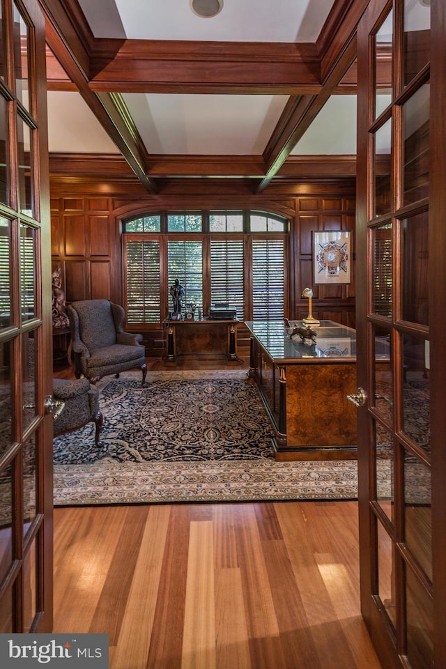 living room featuring light hardwood / wood-style flooring, coffered ceiling, and french doors