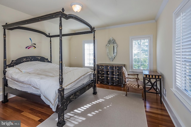 bedroom with dark hardwood / wood-style flooring and ornamental molding