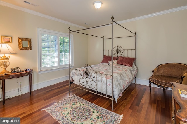 bedroom featuring a notable chandelier, crown molding, and dark hardwood / wood-style flooring