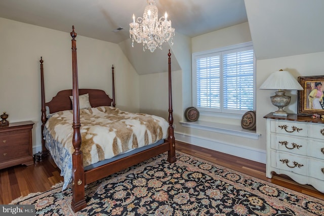 bedroom featuring an inviting chandelier and dark hardwood / wood-style flooring