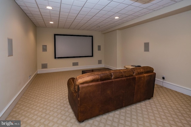 carpeted home theater featuring a paneled ceiling