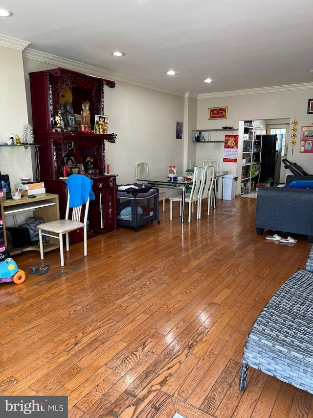 interior space featuring ornamental molding and hardwood / wood-style flooring