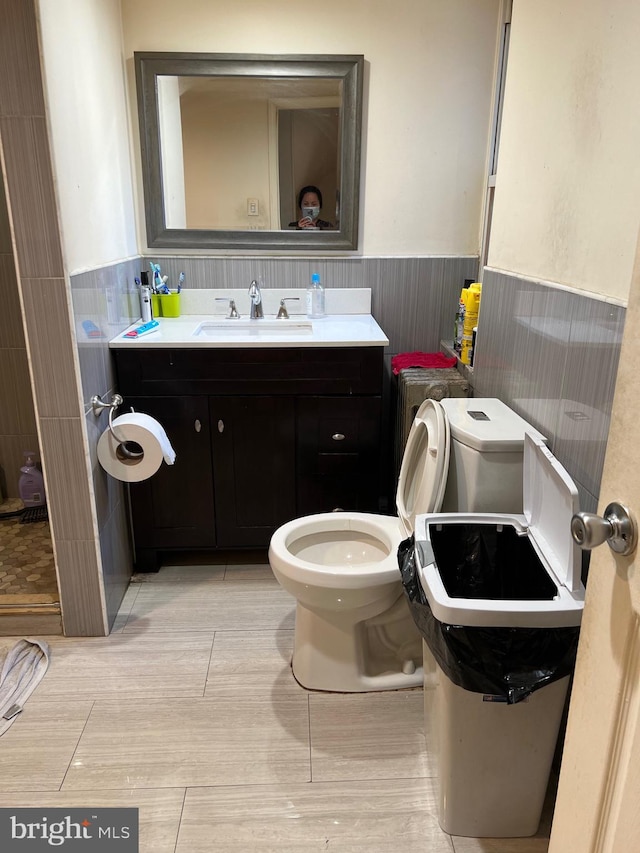 bathroom featuring toilet, tile floors, and vanity