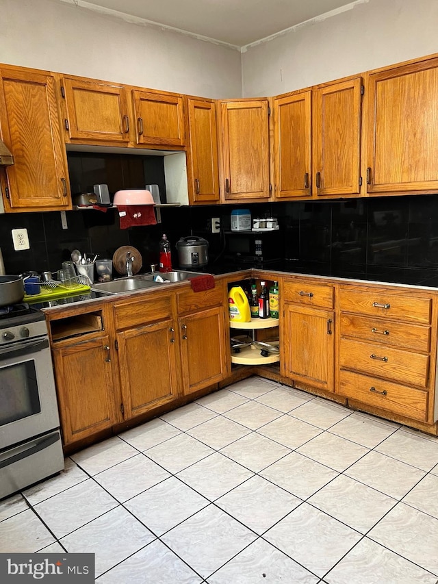 kitchen featuring light tile flooring, stainless steel range oven, and tasteful backsplash