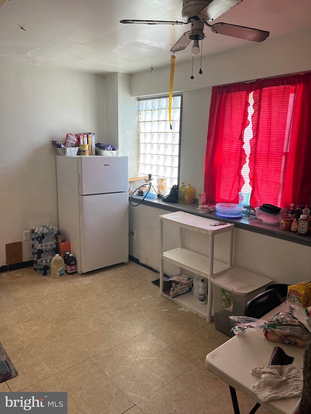 misc room with ceiling fan and light tile flooring