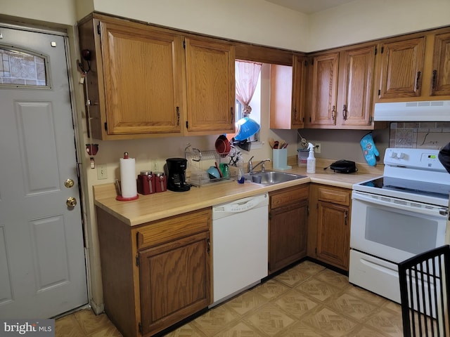 kitchen featuring sink and white appliances