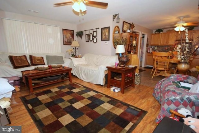 living room featuring ceiling fan and light wood-type flooring