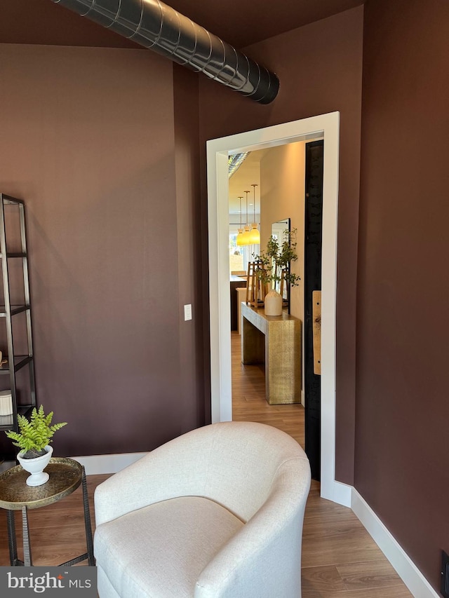 living area with wood finished floors and baseboards