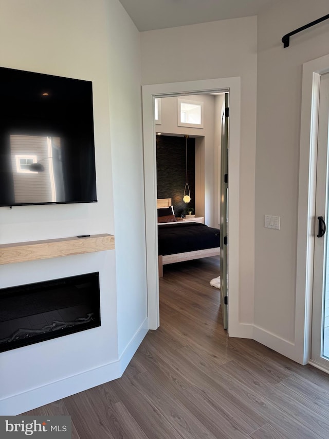 hall featuring baseboards and wood finished floors