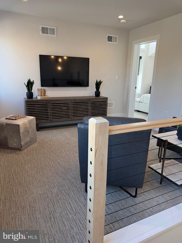 living area with visible vents, carpet flooring, and recessed lighting