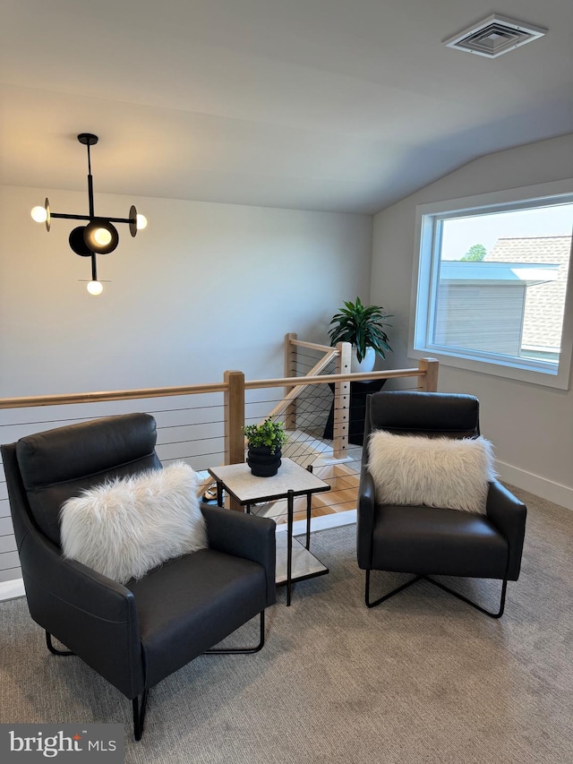 living area featuring lofted ceiling, baseboards, visible vents, and carpet flooring