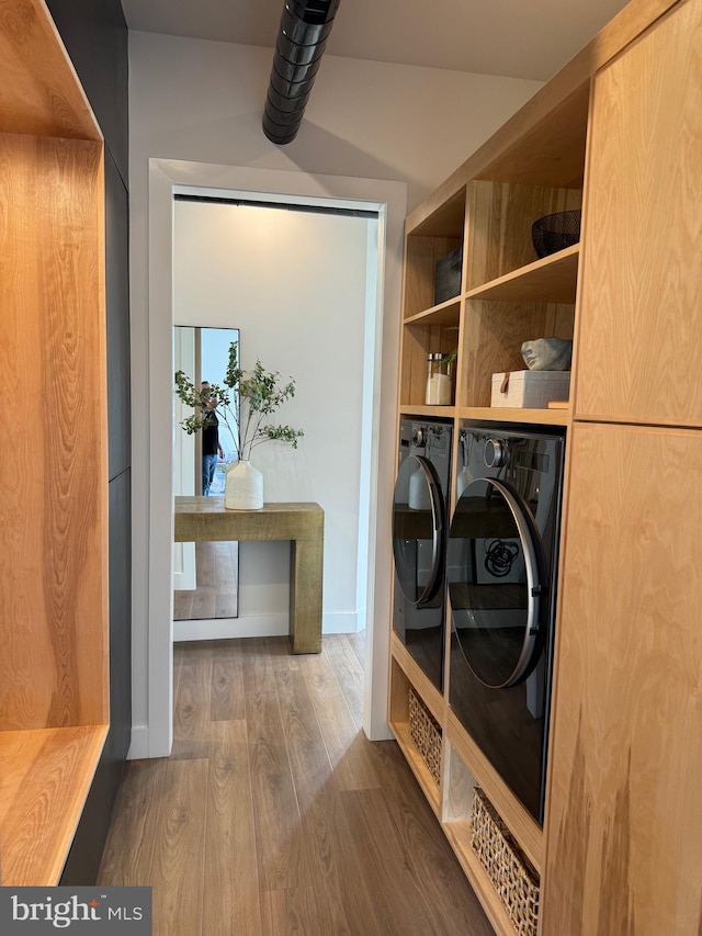 mudroom featuring washing machine and clothes dryer and wood finished floors