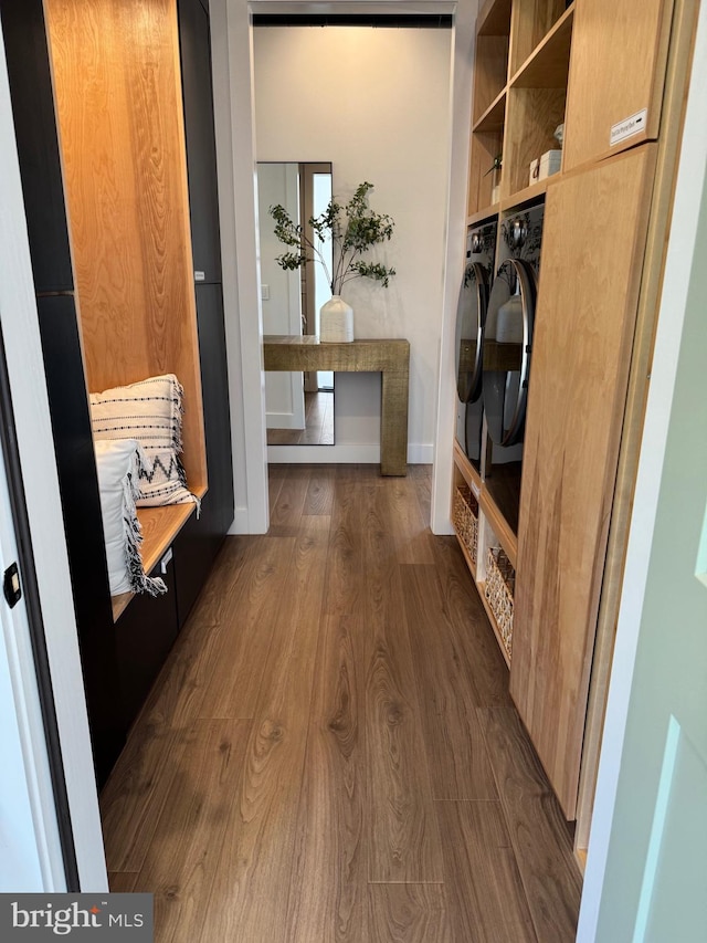 mudroom with separate washer and dryer and dark wood-type flooring