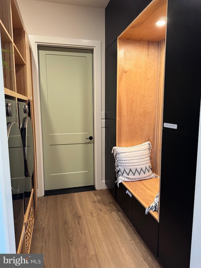 mudroom featuring independent washer and dryer and wood finished floors