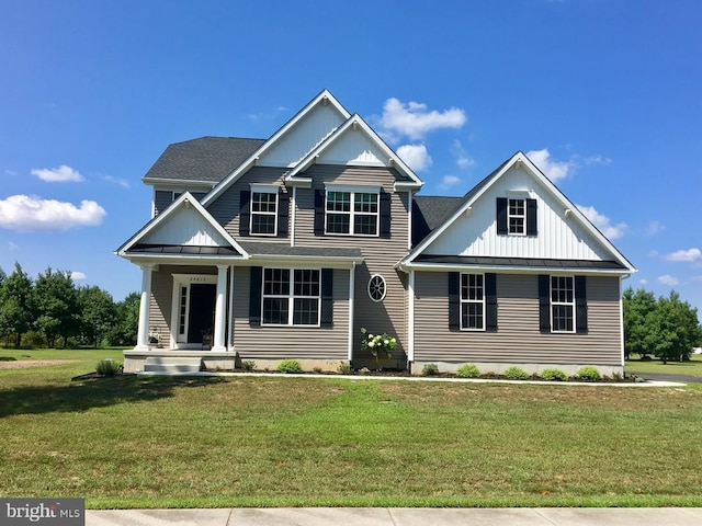 craftsman-style house featuring a front yard and covered porch