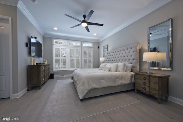 bedroom with ceiling fan, ornamental molding, and hardwood / wood-style floors