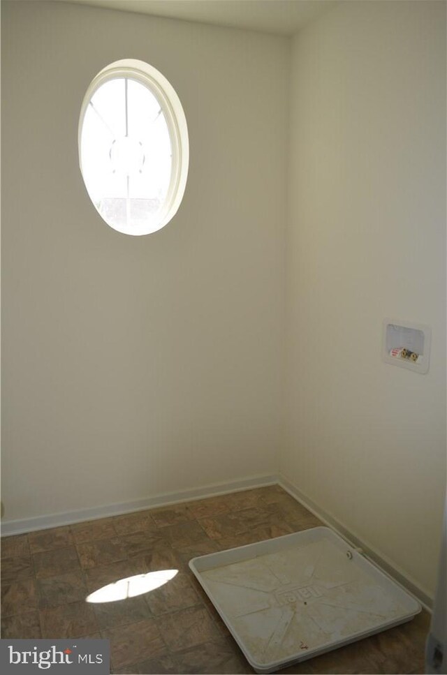 empty room with dark tile flooring