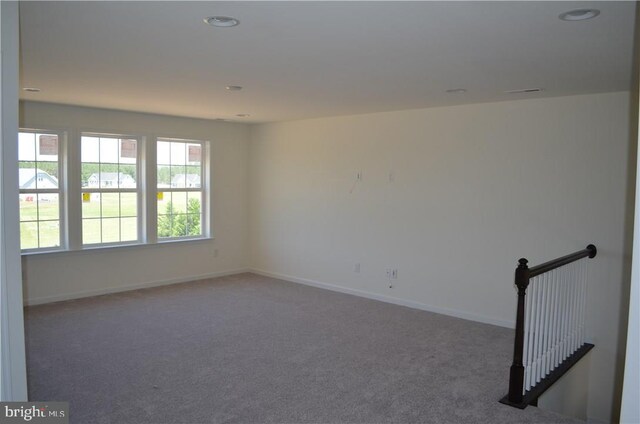 empty room with dark carpet