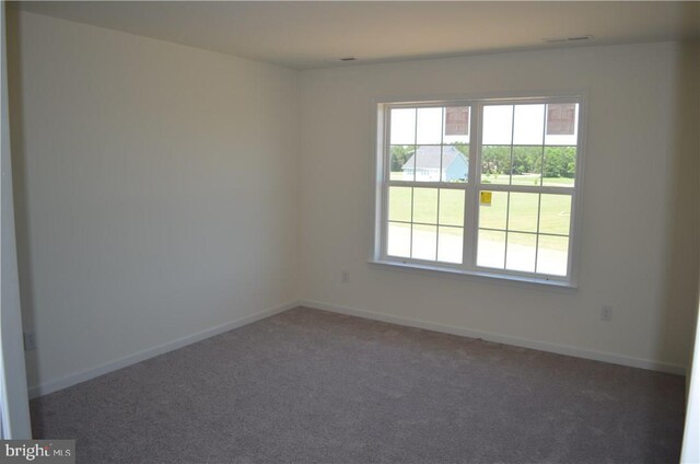 unfurnished room featuring dark carpet