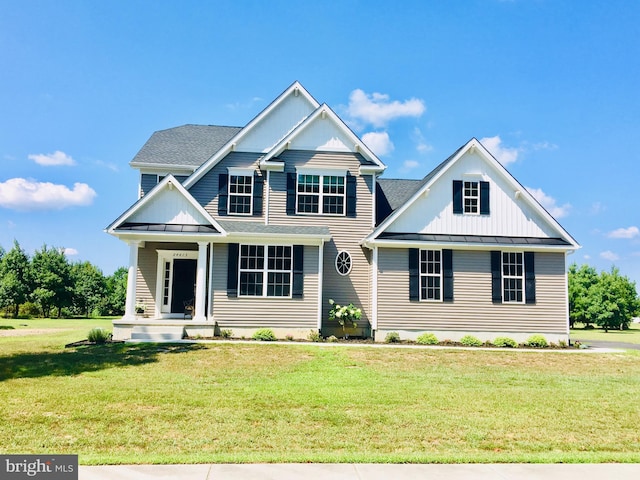 view of front of house with a front yard and covered porch