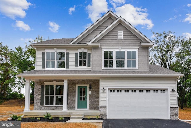 craftsman house with a porch and a garage