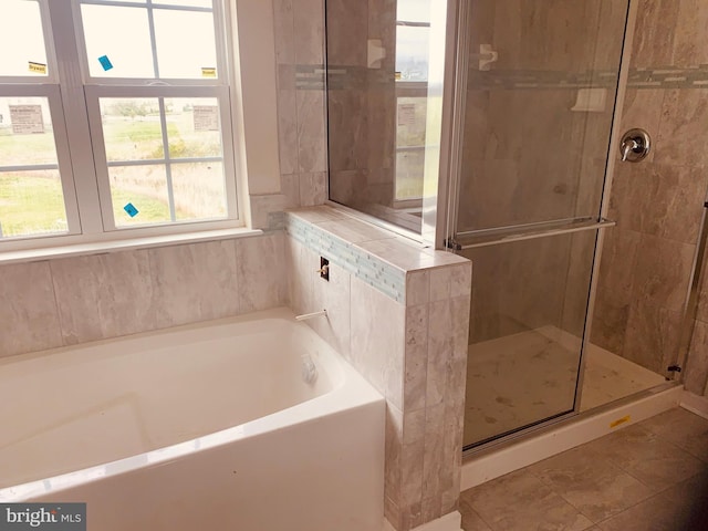 bathroom featuring tile flooring and plus walk in shower