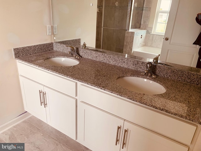 bathroom with tile flooring, a bathtub, and dual bowl vanity