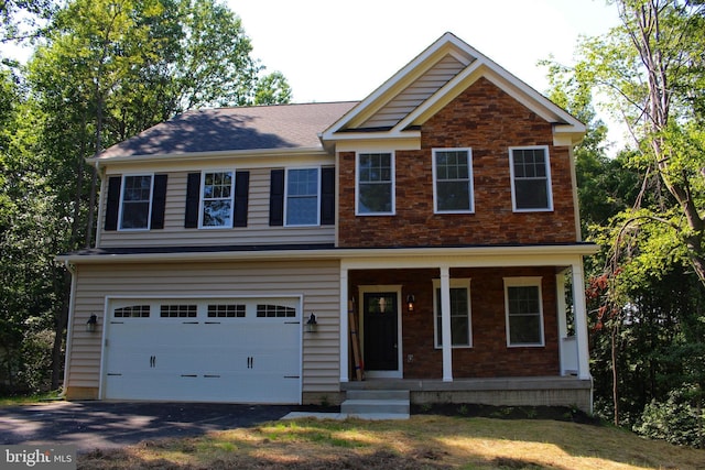 view of front of home featuring covered porch and a garage