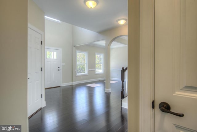 entryway with crown molding and dark hardwood / wood-style floors