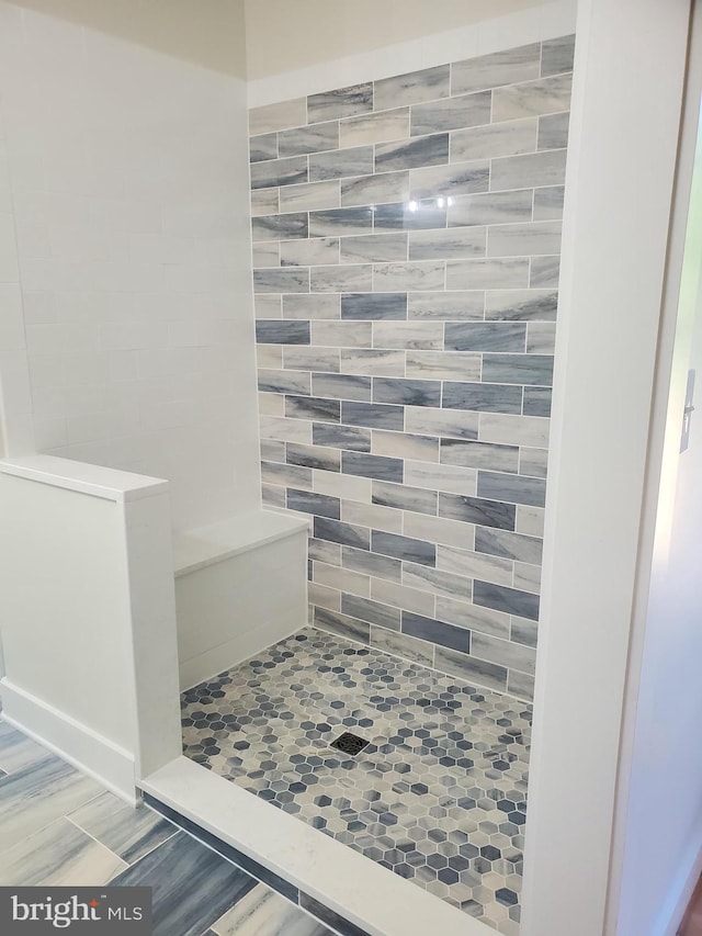 bathroom featuring tile floors and a shower