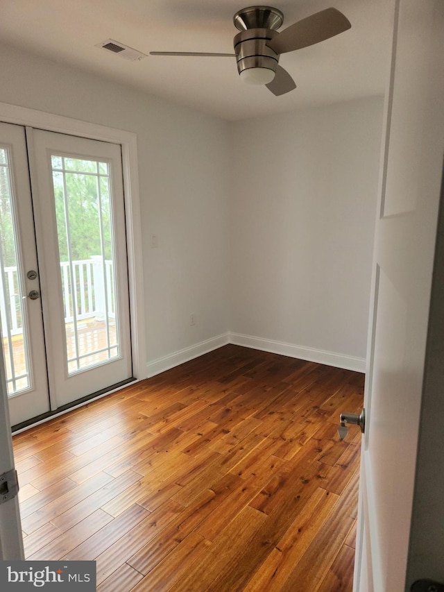 unfurnished room featuring ceiling fan and hardwood / wood-style flooring