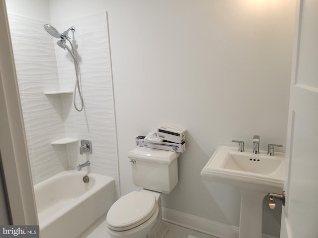 full bathroom with tiled shower / bath combo, toilet, and sink