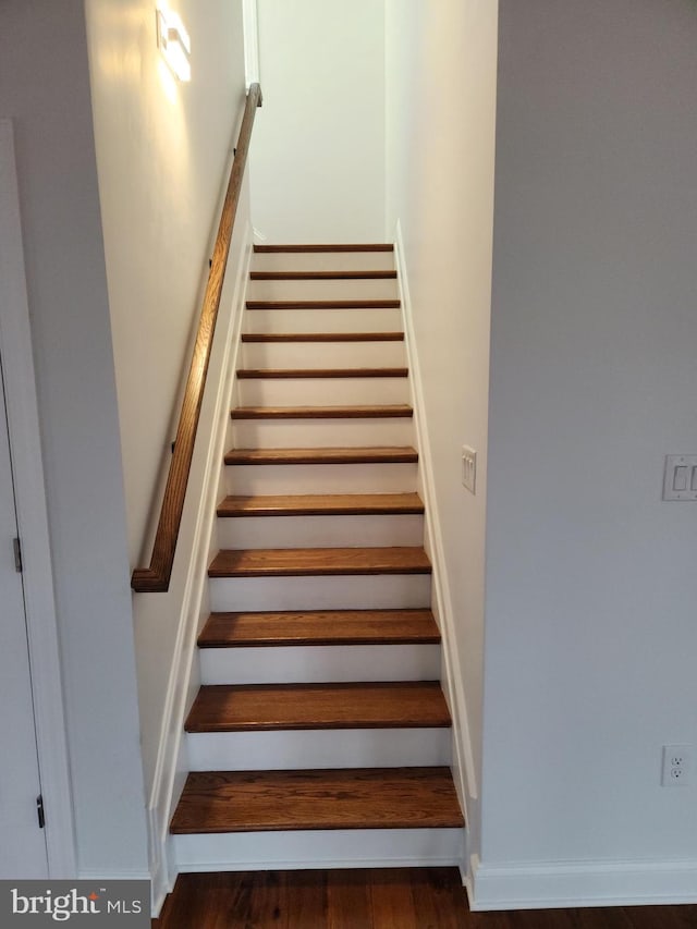 stairway with dark wood-type flooring