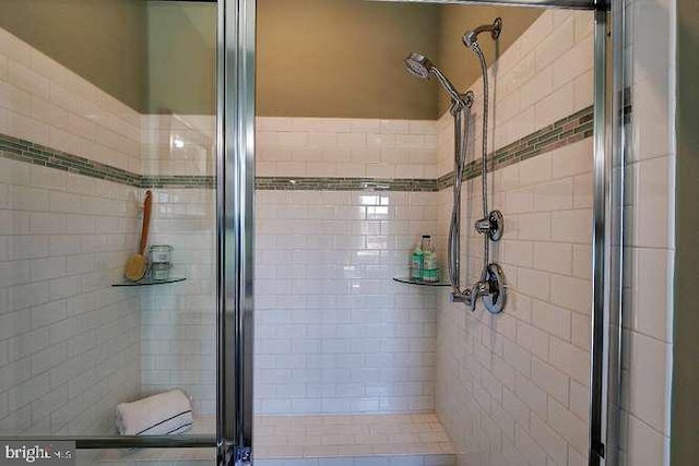 bathroom featuring a shower with door