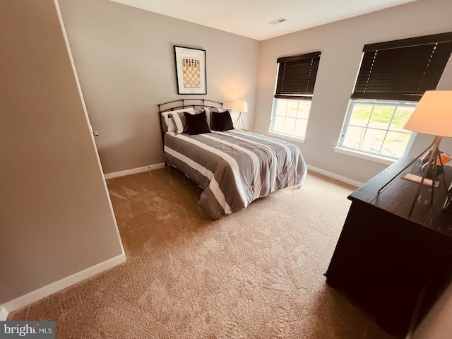 bedroom with dark colored carpet