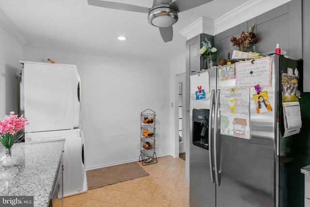 kitchen featuring ceiling fan, stacked washer and dryer, light tile floors, stainless steel refrigerator with ice dispenser, and ornamental molding