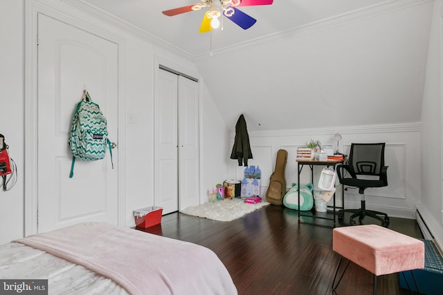 bedroom with a closet, dark hardwood / wood-style floors, ceiling fan, baseboard heating, and ornamental molding