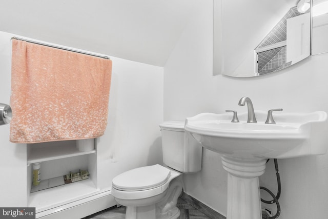 bathroom with lofted ceiling, tile flooring, and toilet