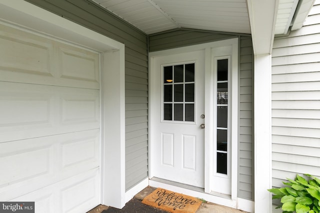 view of exterior entry featuring a garage