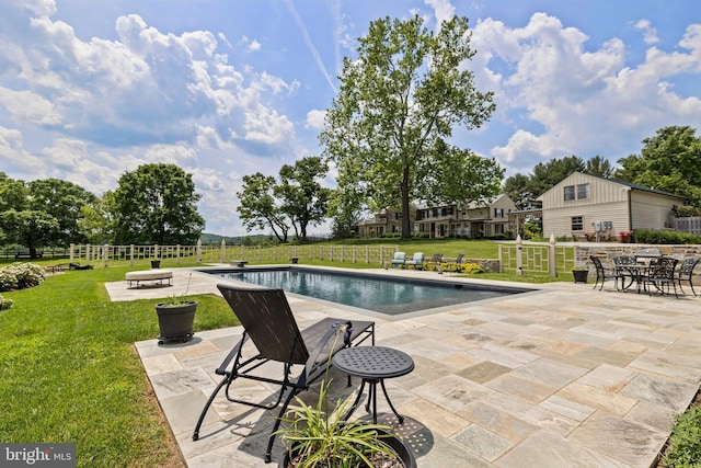 view of pool featuring a yard and a patio area