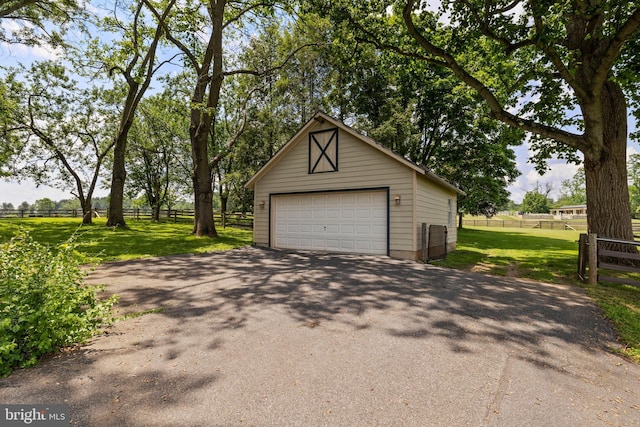 garage featuring a lawn