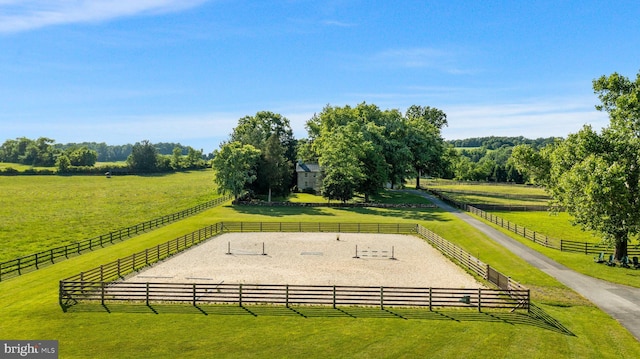 view of property's community with a rural view and a yard