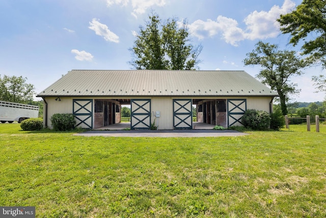 rear view of house with a yard and an outdoor structure