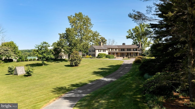 view of property's community with a yard